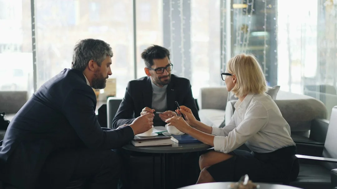 A small-business owner discussing business documents with a consultant